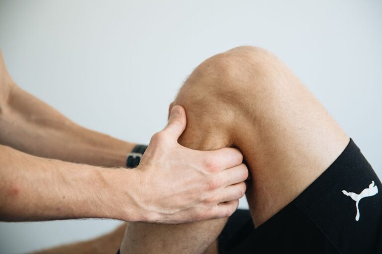 Physical therapist treating a patient's knee during non-surgical knee bursitis treatment in Riverdale, GA