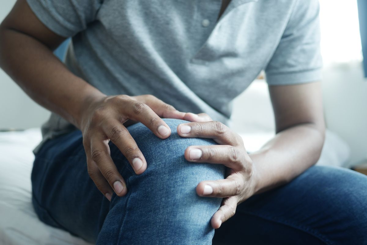 Person holding a knee affected by knee crepitus before non-surgical evaluation in Riverdale, GA