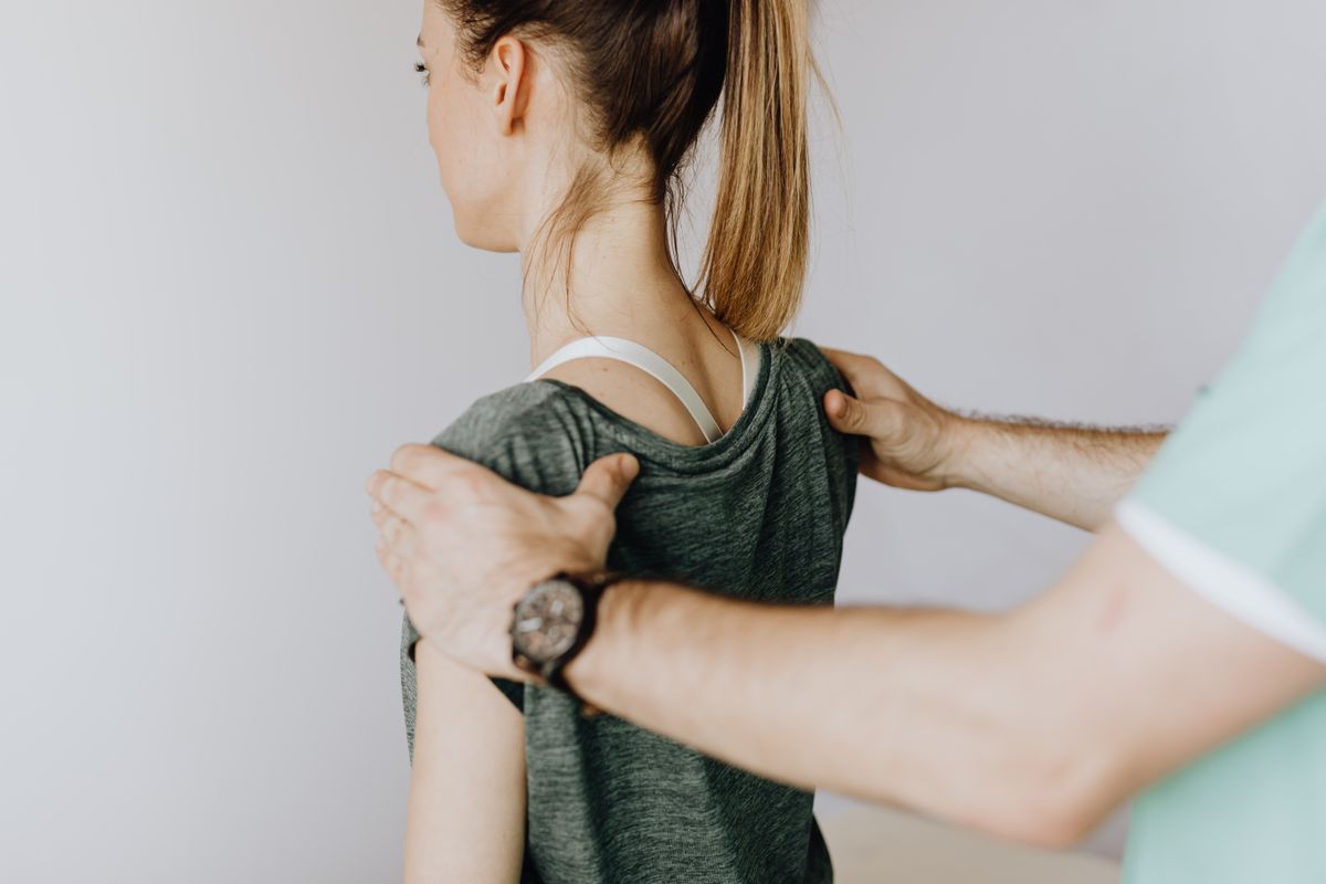 Doctor assessing shoulder range of motion during a shoulder bursitis evaluation in Riverdale, GA