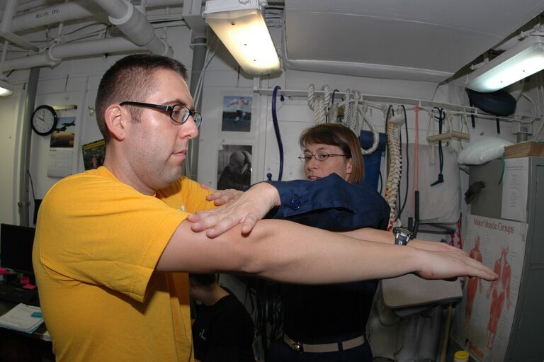 Clinician checking shoulder range of motion while reviewing shoulder replacement alternatives